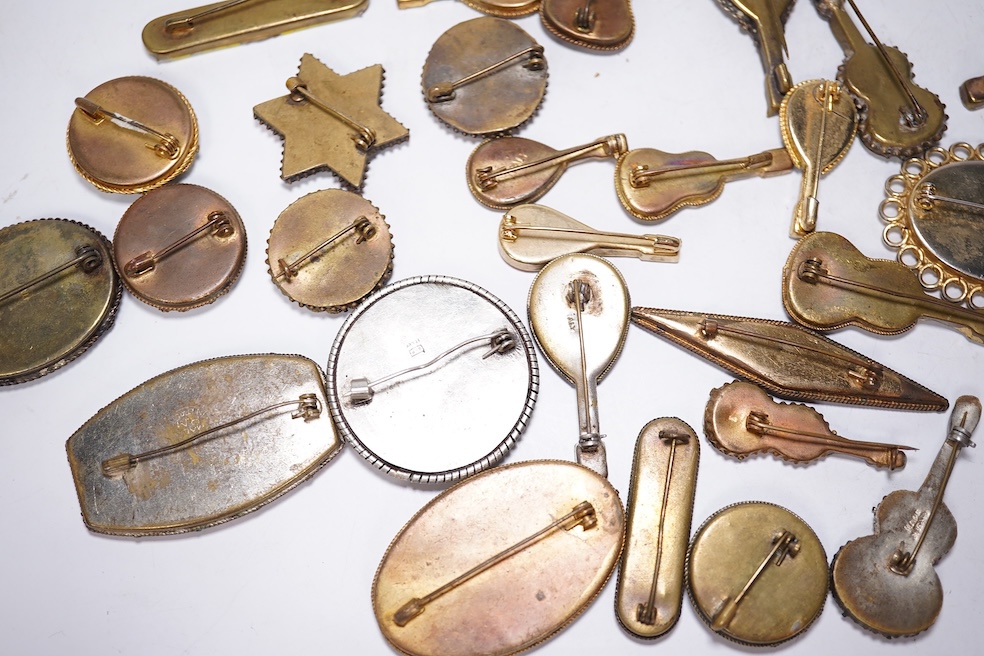 A collection of thirty-one micro-mosaic brooches, including fourteen mixed guitar and banjo shaped brooches, six large oval brooches and seven smaller brooches, three long brooches and a star shaped brooch. Condition - g
